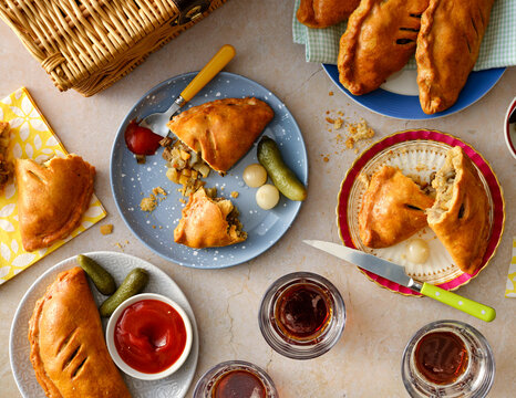 Picnic food, Cornish pasties on table with condiments. 
