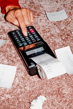 man uses a calculator to do some calculations