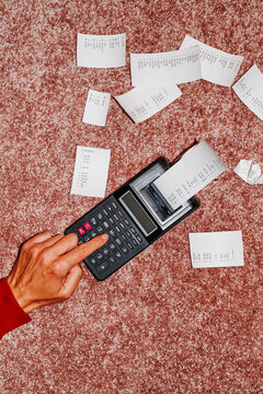 man using an electronic calculator on the  floor