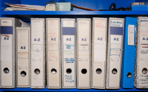Receipt archive folders in blue shelf