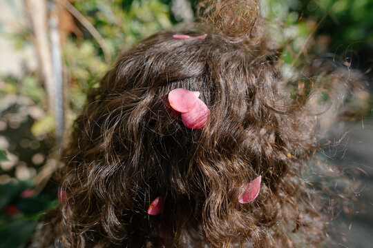 girl's curls with rose petals