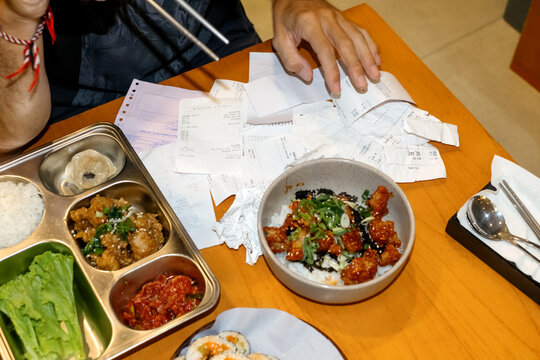 Businessman Calculating Expenses Over Lunch at a Cafe During a workday