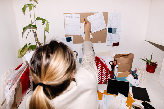 Unrecognizable woman examining papers in office