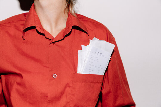 Crop woman with receipts in pocket 