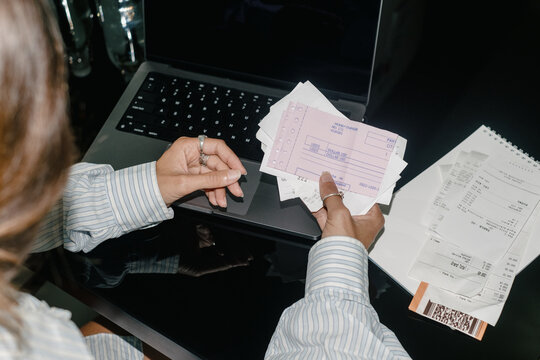 Close-Up of a Woman Sorting Through Paperwork at Her Home Office Desk