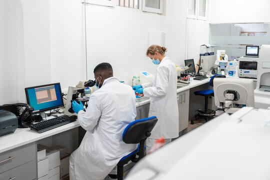 Team of Research Scientists Working On Computer