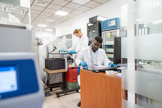 Team of Research Scientists Working On Computer