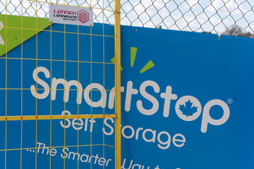 Fototapeta premium barrier fences and poster announcing future site of a Smart Stop self-storage facility along Jane Street in Toronto, Canada