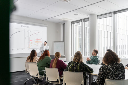 Man Performing PhD Thesis Defence To Audience