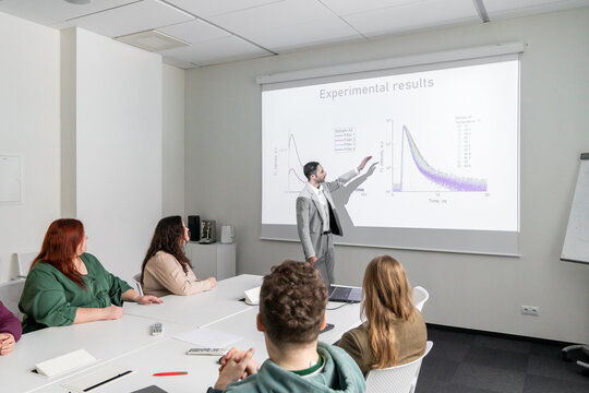 Man Performing PhD Thesis Defence To Audience