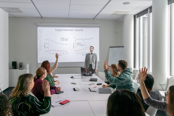 People Rising Hands To Ask Questions At PhD Thesis Defence