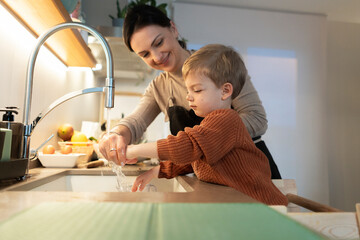Mother and son cleaning hands