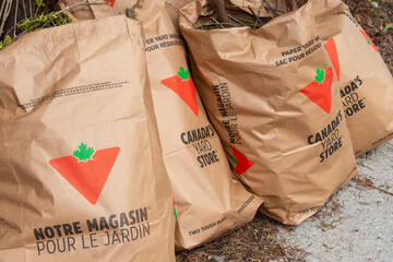 Fototapeta premium plain brown paper yard waste bags with compostable material and Canadian Tire branding in Toronto, Canada
