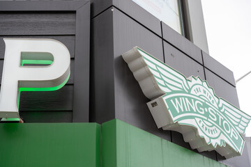 Fototapeta premium logo sign of Wingstop, a chicken wings restaurant, located at 2218 Bloor Street West in Toronto, Canada
