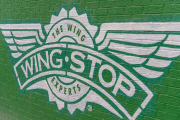 Fototapeta premium painted mural logo sign outside Wingstop, a chicken wings restaurant, located at 2218 Bloor Street West in Toronto, Canada