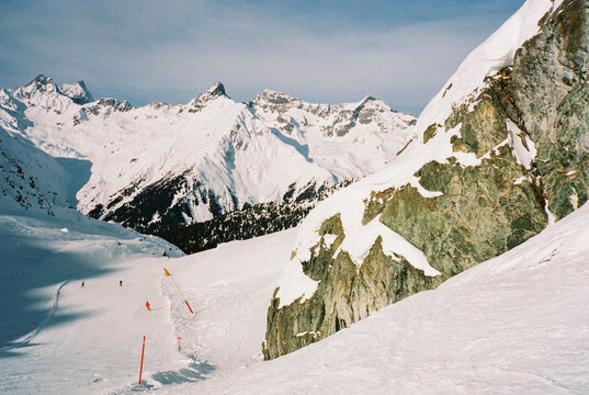 Landscape of snowy mountains and ski pistes 