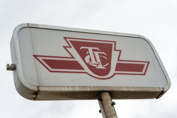Fototapeta premium TTC logo sign on a cloudy sky located at Runnymede Road and Dundas Street West loop in Toronto, Canada