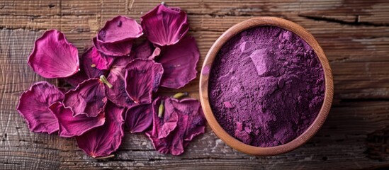 Bowl of Purple Powder Beside Pile of Purple Flowers