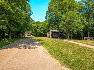 Long View of a road running through the restored village of Lincoln's New Salem. Log cabins can be seen in the distance. Abraham Lincoln lived here from 1831 to 1837.