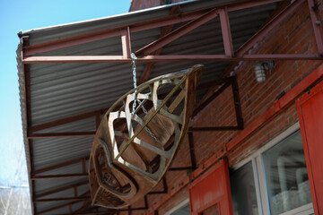 Obraz premium decorative wooden kayak boat structure hanging from the underside armature of a building at Evergreen Brick Works in Toronto, Canada