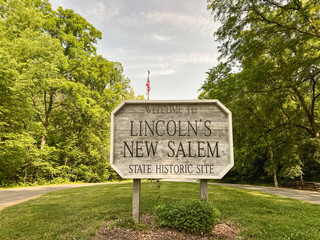 Rectangular wooden sign at the entrance to Lincoln's New Salem Historic Site. A reconstruction of...