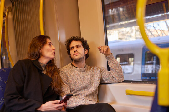 Friends sharing a fun ride on the metro
