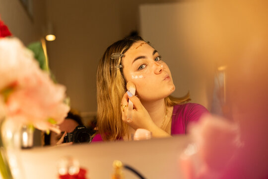 teen girl applying contouring makeup 