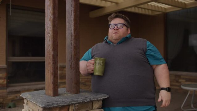 Man with mug slowly getting pissed off - medium shot