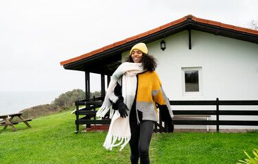 Young woman enjoying a cool day by the seaside
