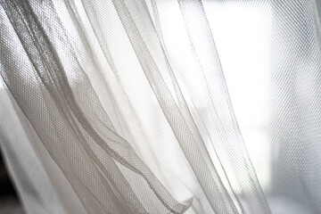 Sheer white curtains bathing in soft daylight