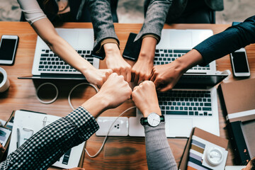 Closeup team of business collaborators bumping fists