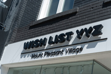 Fototapeta premium exterior building and sign of Wish List YYZ, a women's clothing store, located at 629 Mount Pleasant Road in Toronto, Canada