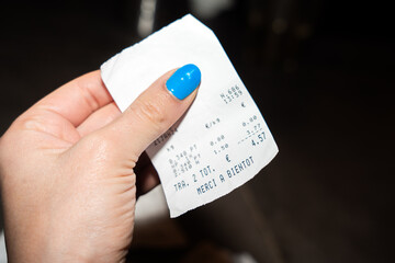 Female Hand Holding A Business Receipt.