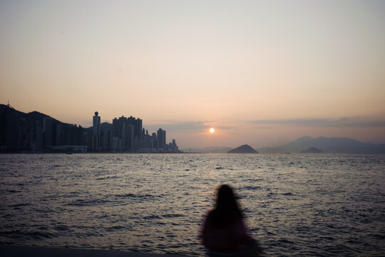 Girl on a seaside boardwalk in Hong Kong