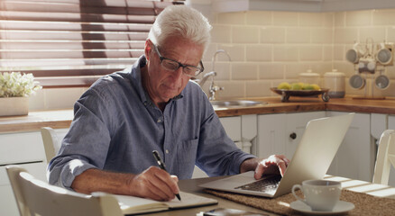 Finance, laptop and writing with senior man in kitchen of home for investment, pension or...