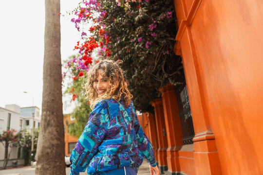 Curly Hair Young Woman Walking on the Street