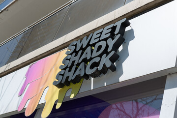Fototapeta premium upward glance at sign outside Sweet Shady Shack, a bubble tea store, located at 220 Eglinton Avenue East in Toronto, Canada
