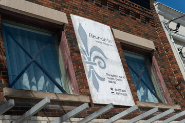 Fototapeta premium old sign on the facade of 294 Eglinton Avenue West in Toronto, Canada (Fleur de lis interior design)