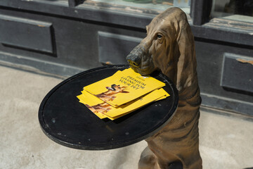 Fototapeta premium dog sculpture with serving tray and colorful pet grooming brochures located in front of DogStar pet boutique (292 Eglinton Avenue West) in Toronto, Canada