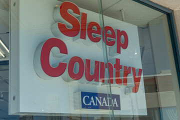 Fototapeta premium channel lettering sign inside window at Sleep Country Canada located at 256 Eglinton Avenue West in Toronto, Canada