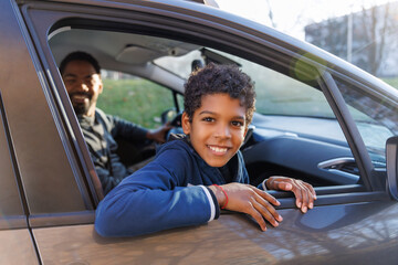 Portrait of happy boy in car