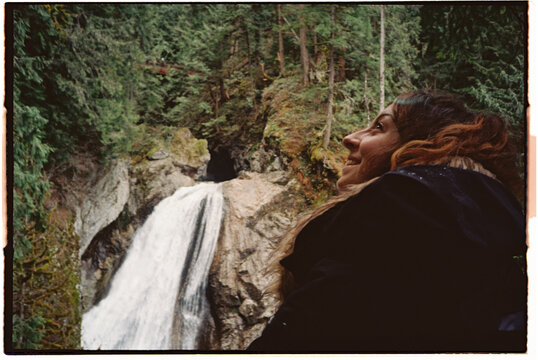 Film photo Smiling woman at waterfall