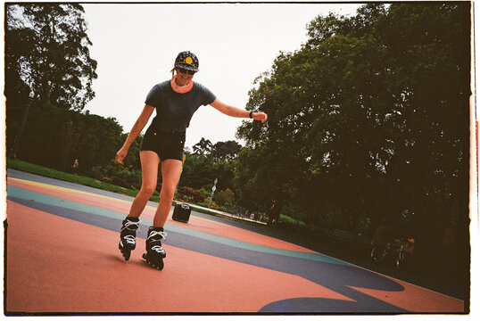 35mm Film: Woman in shorts rollerblading 