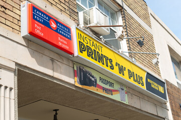Fototapeta premium exterior building and sign of Instant Prints N Plus, a copy shop, located at 922 Eglinton Avenue West in Toronto, Canada