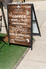 Fototapeta premium exterior sidewalk and patio turf with a-frame sandwich board frame of Cafe On The Hill located at 916 Eglinton Avenue in Toronto, Canada