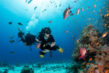 Mother and son Scuba Diving at Coral Reef underwater