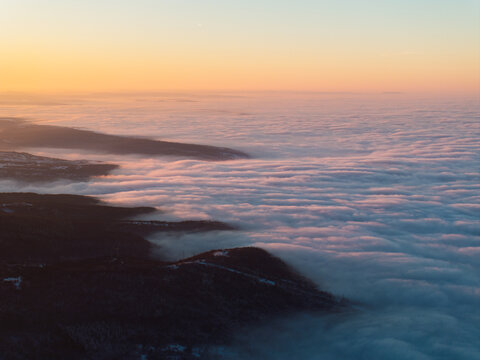 Sunset above rolling fog / clouds