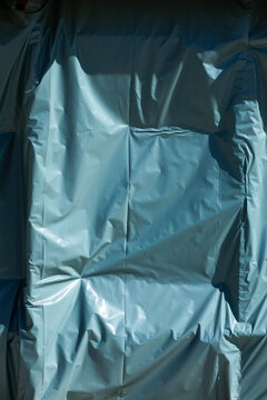 Background texture of plastic covering shaped by wind