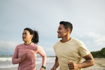 Athletic friends jogging on the beach