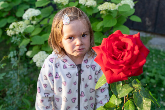 sad child among flowers 